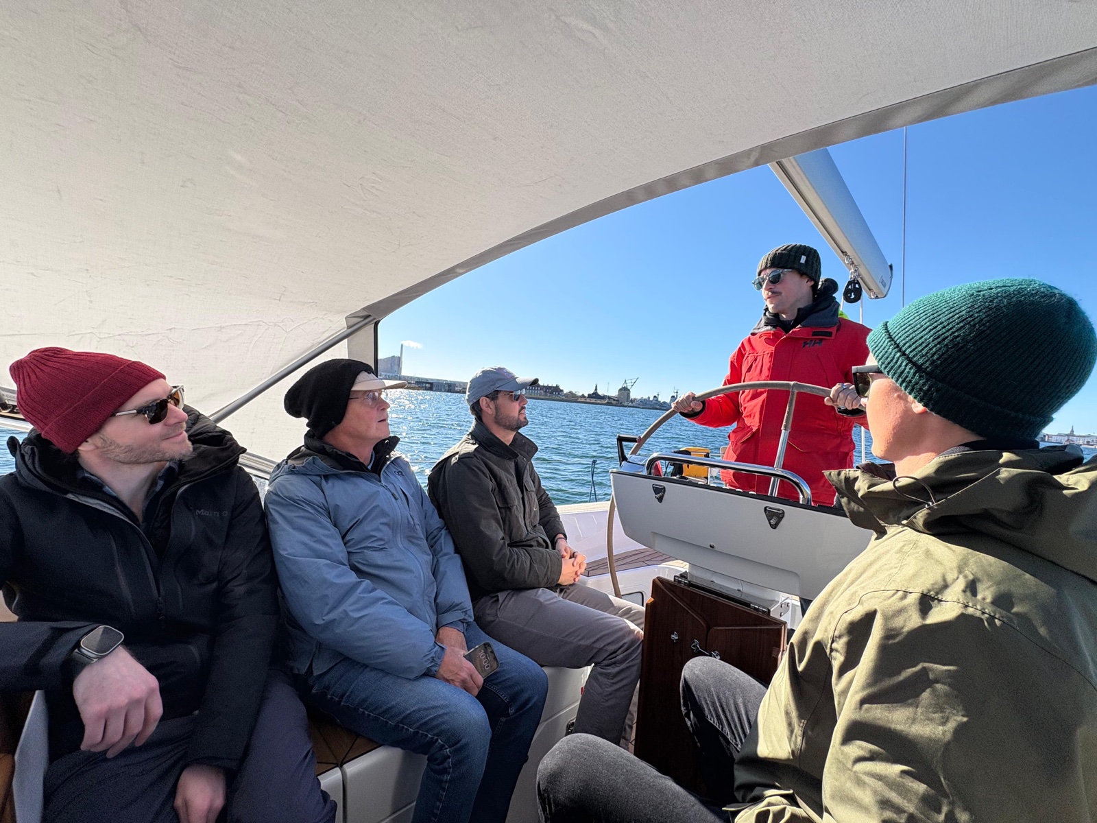 Full crew in the cockpit — Lisa, Cam's dad, Cam, Kyle at the helm, and Eric
