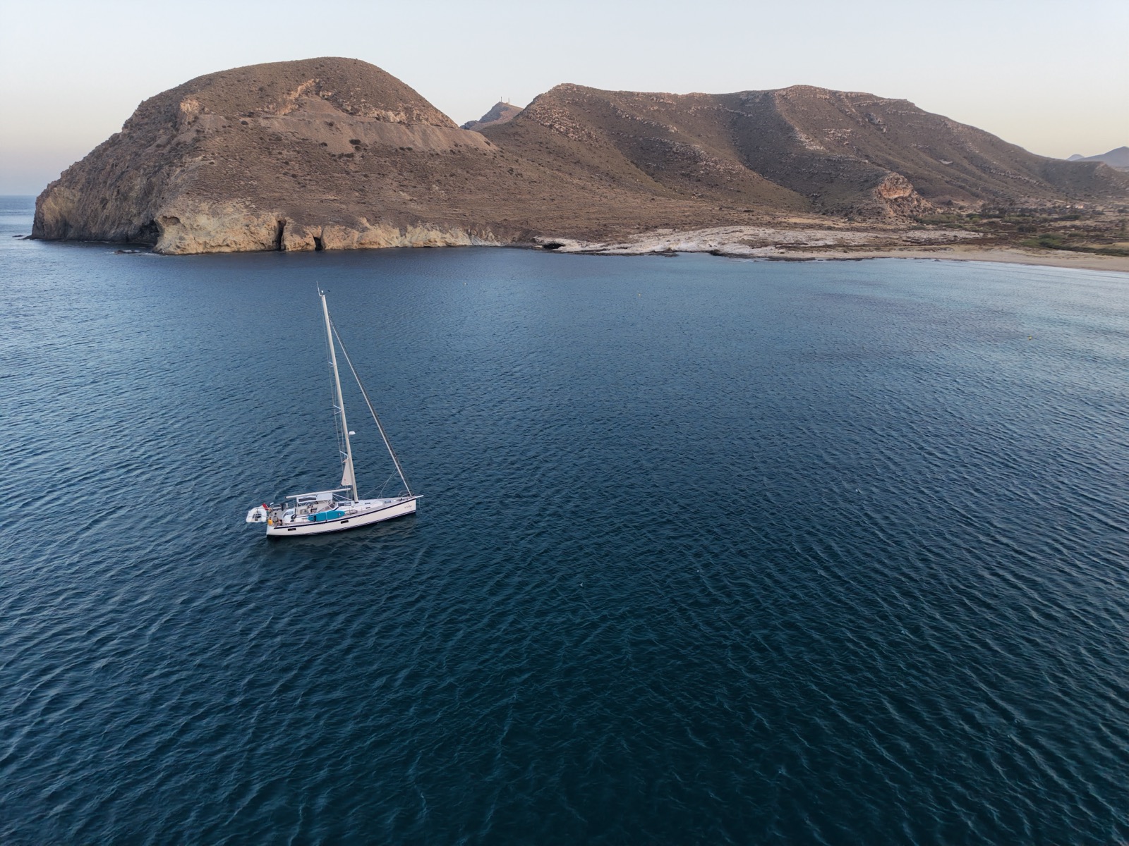 Anchored off a beach with cliffs and ruins
