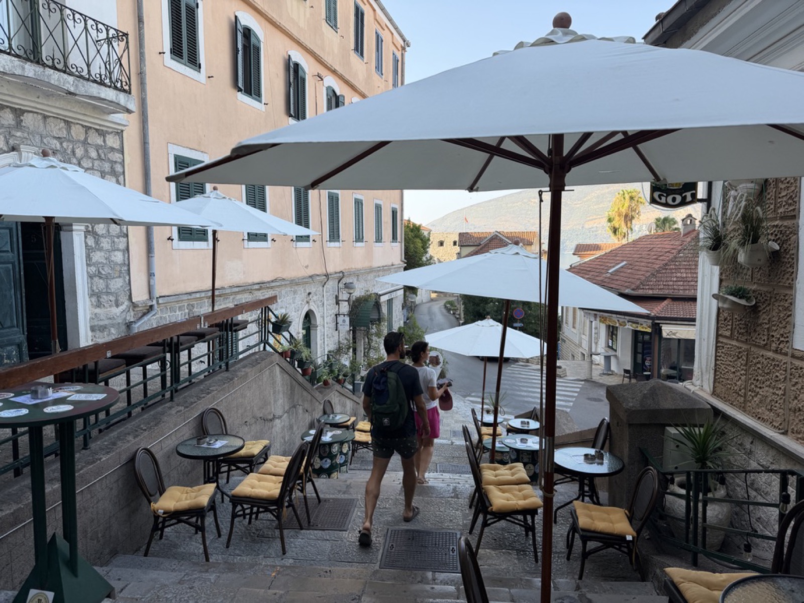 A stairway restaurant with tables set up on the steps in Herceg Novi