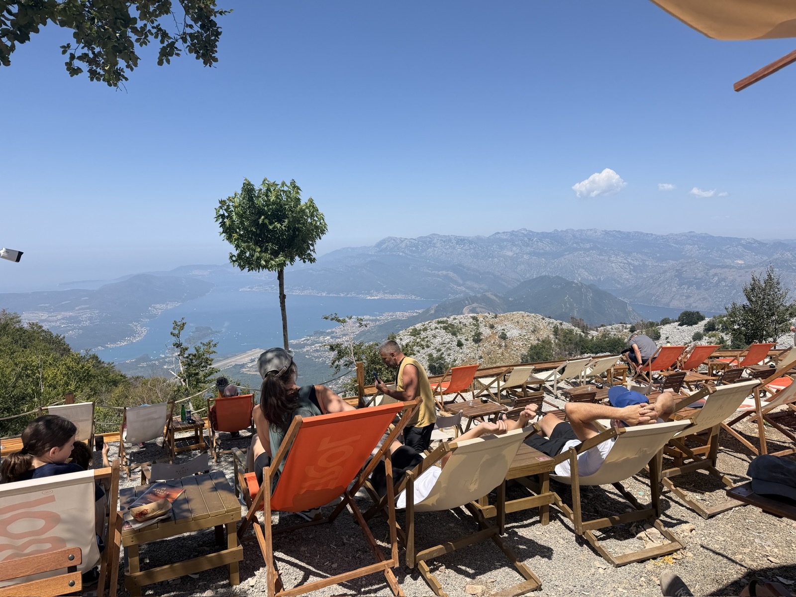 Deck chairs at a mountainside cafe above the bay