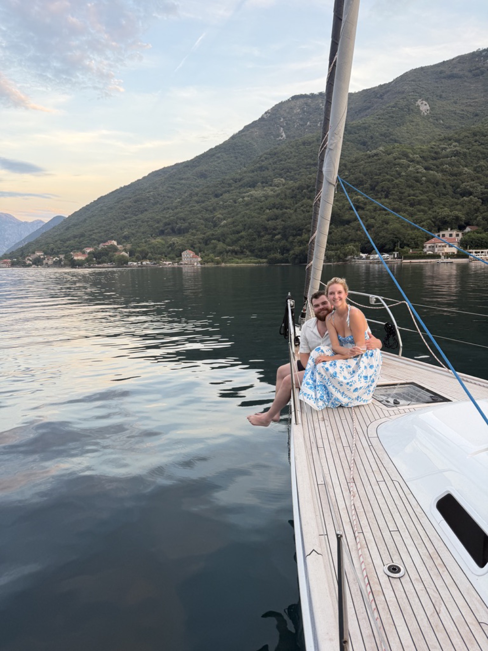 Meg and Andrew sitting on the bow at sunset