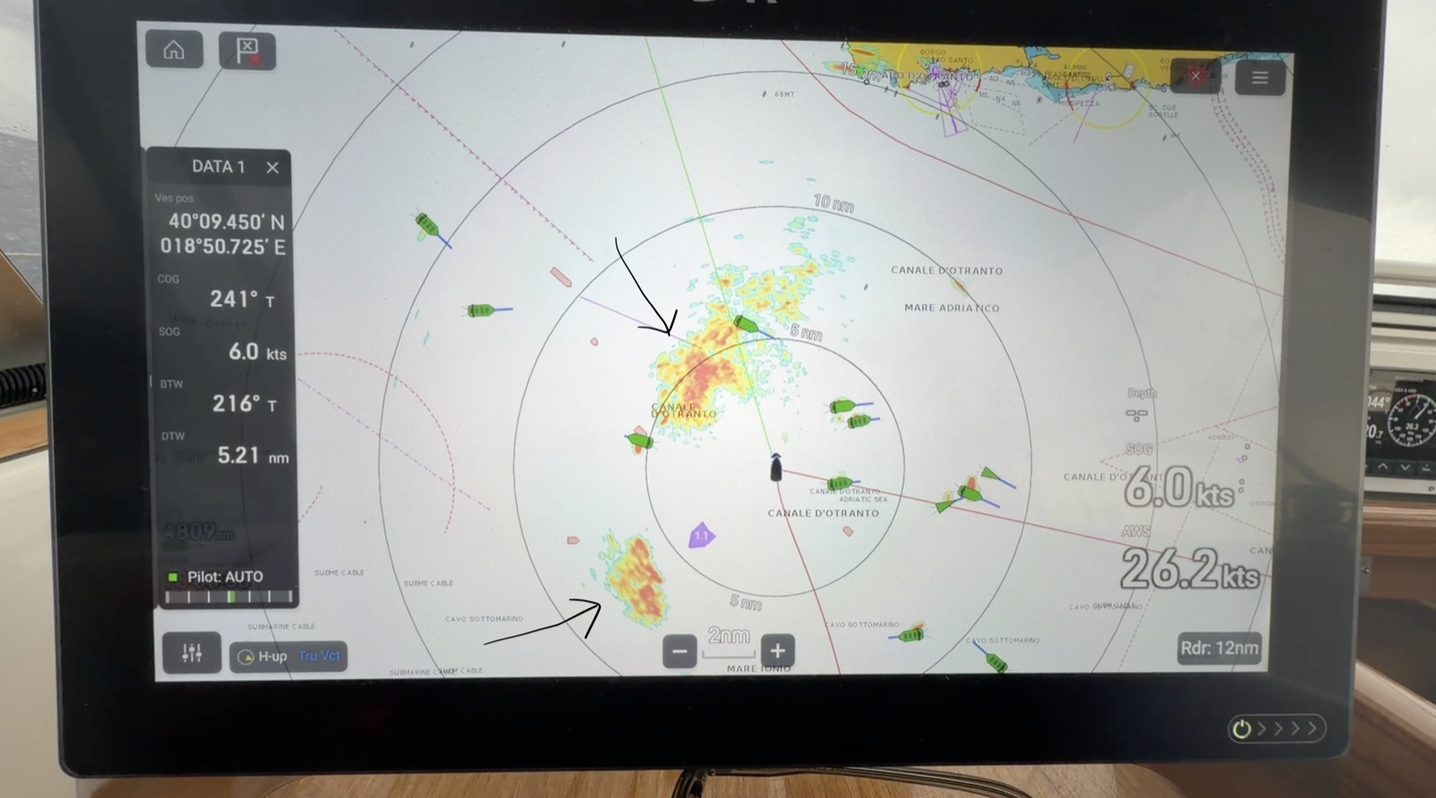 Radar screen showing two squall cells ahead, marked with arrows