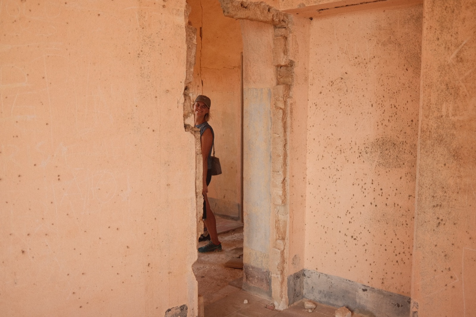 Peeking around a doorway inside the castle's crumbling rooms